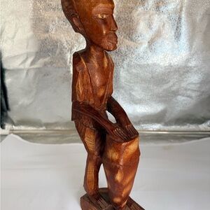 Handcrafted Wooden Sculpture Featuring Man Playing a Drum.